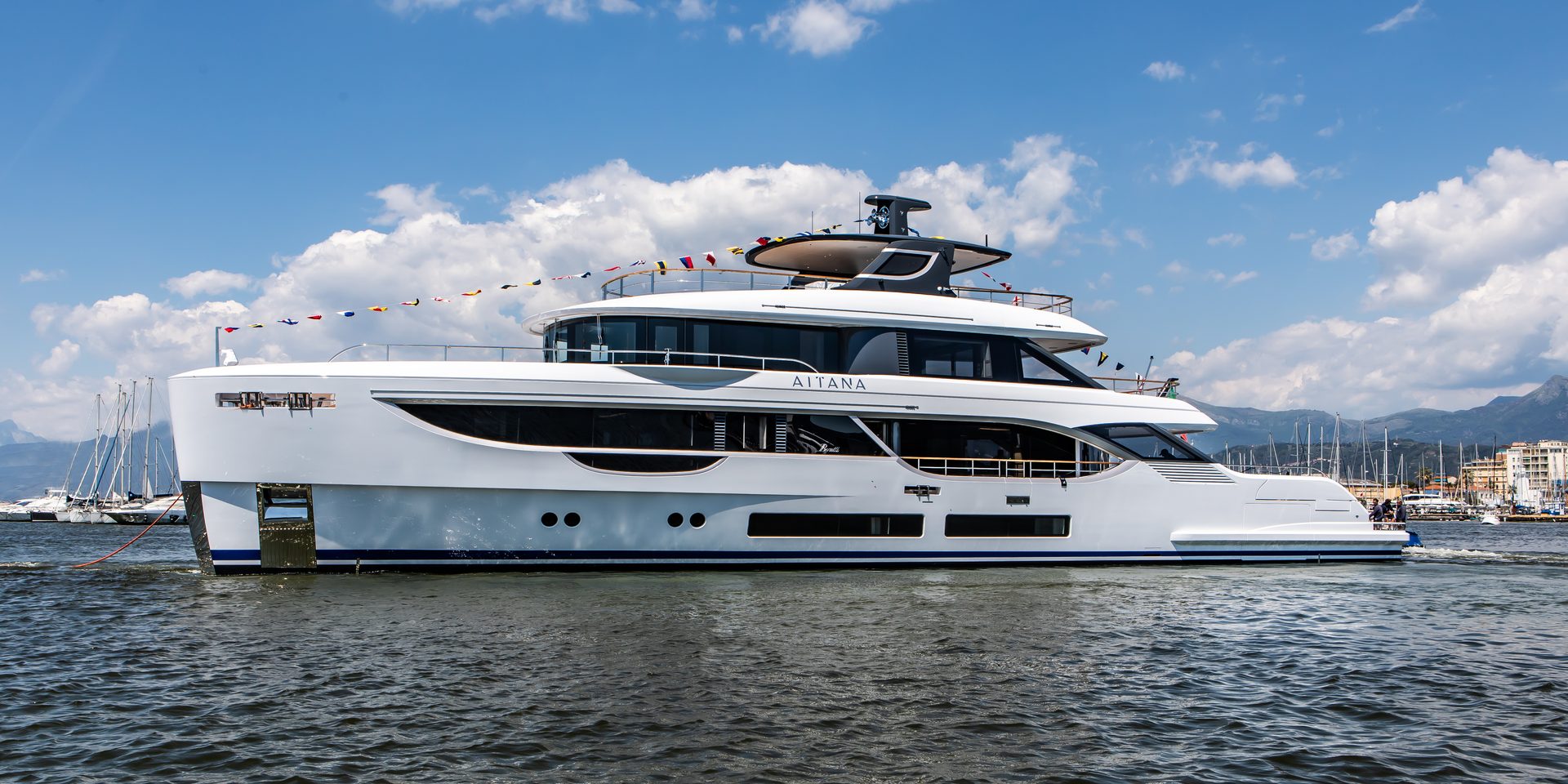 The 34-metre motor yacht at anchor off the coast, seen from the water