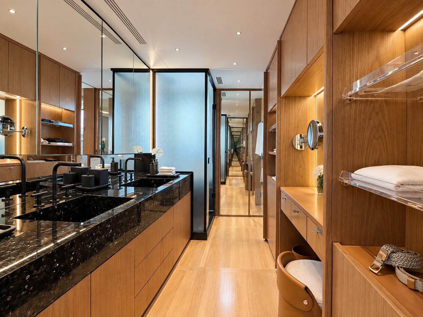 Galley in dark marble and oak, looking down the corridor towards the guest cabins
